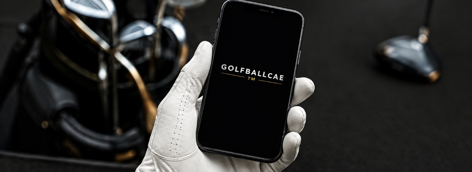 Golfer holding a phone showing the GolfBallers UK site